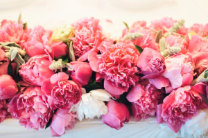 floral arrangement of pink peonies with leaves